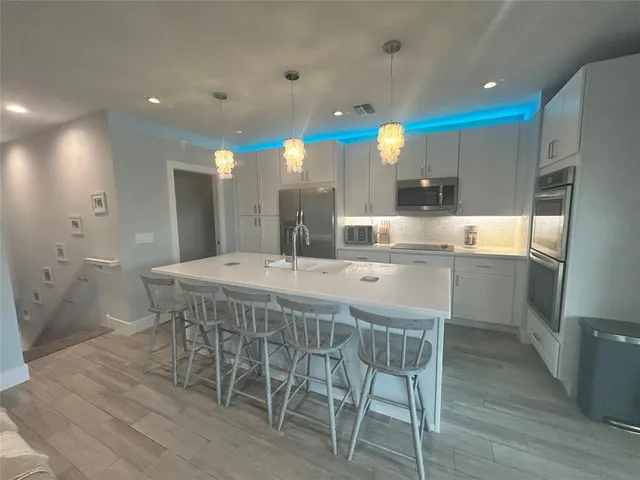 a large kitchen with a table and chairs