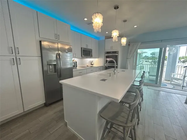 a view of a kitchen area with furniture a fireplace and wooden floor