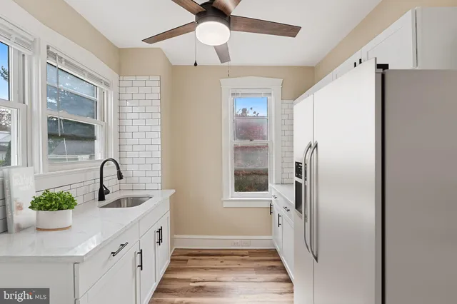 a kitchen with stainless steel appliances a refrigerator and a sink