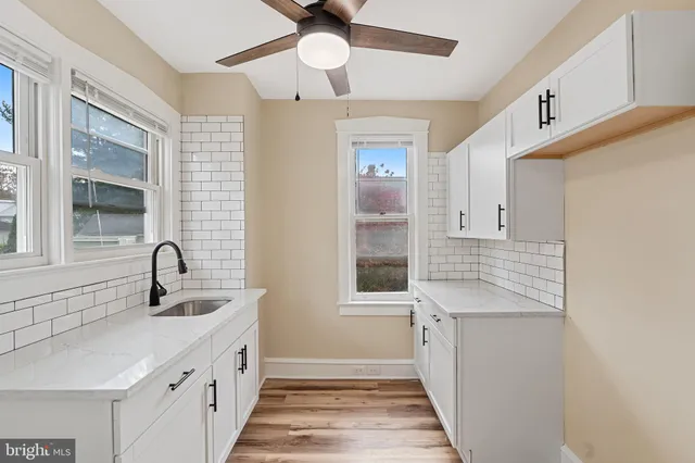 a kitchen with granite countertop a sink and a window