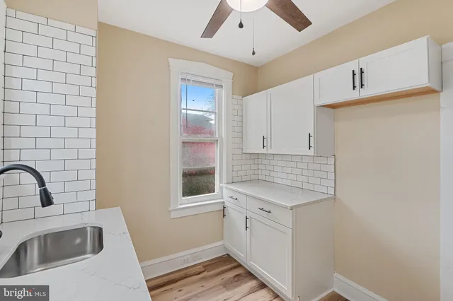 a kitchen with a sink cabinets and window