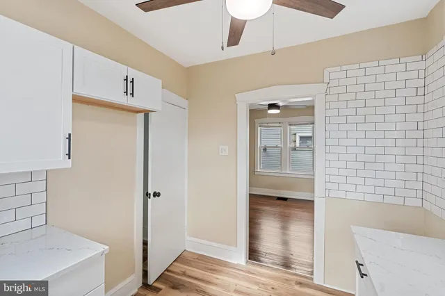 a view of hallway with wooden floor