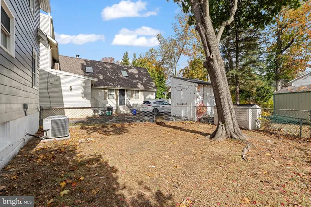 a view of a backyard with a tree