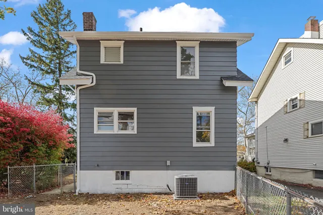 a view of a house with a window and wooden fence