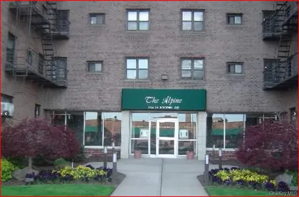 a front view of a house with a garden and plants