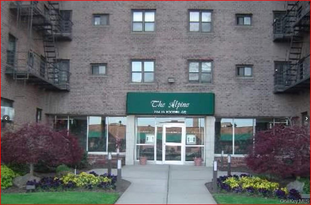 a front view of a house with a garden and plants