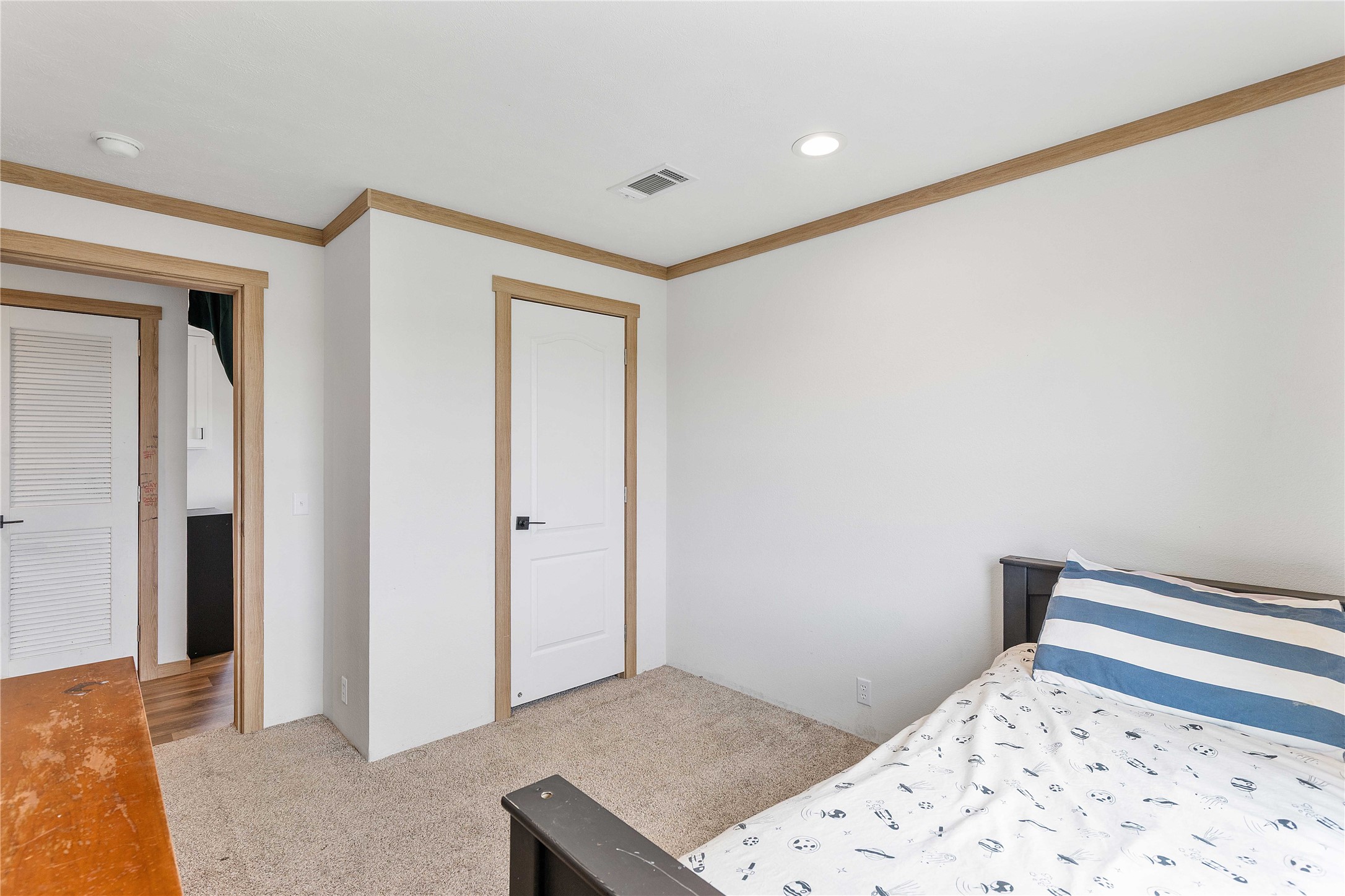 21550 Wilber Road Winnie, TX 77665 - Photo 25 of 28 a bedroom with a bed and a dresser