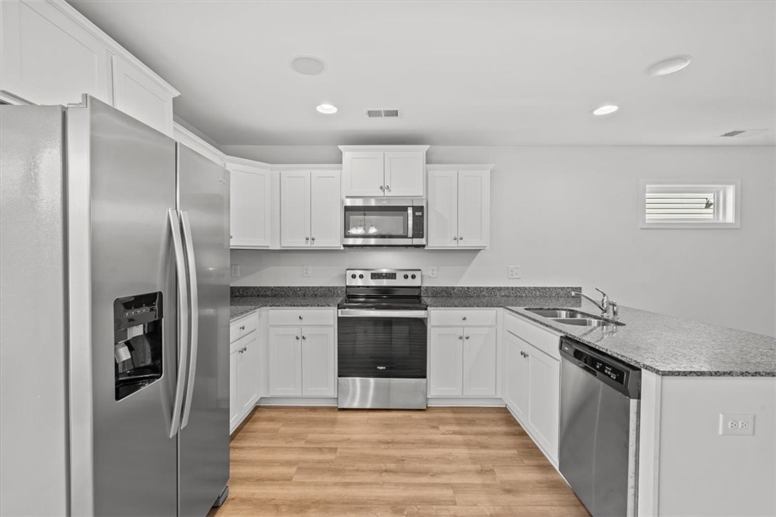 118 Adger Road Pendleton, SC 29670 - Photo 7 of 31 This modern kitchen features bright cabinetry, sleek countertops, and contemporary appliances for everyday living.