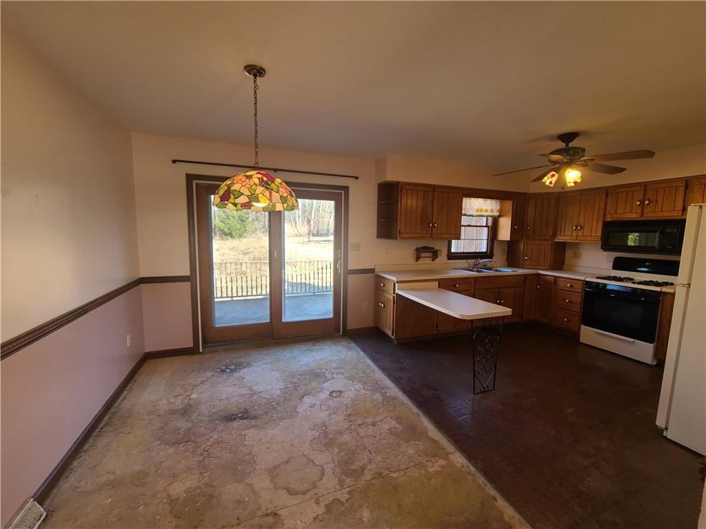 437 Pittsburgh Road Rochester, PA 15074 - Photo 7 of 25 a kitchen with sink refrigerator and window