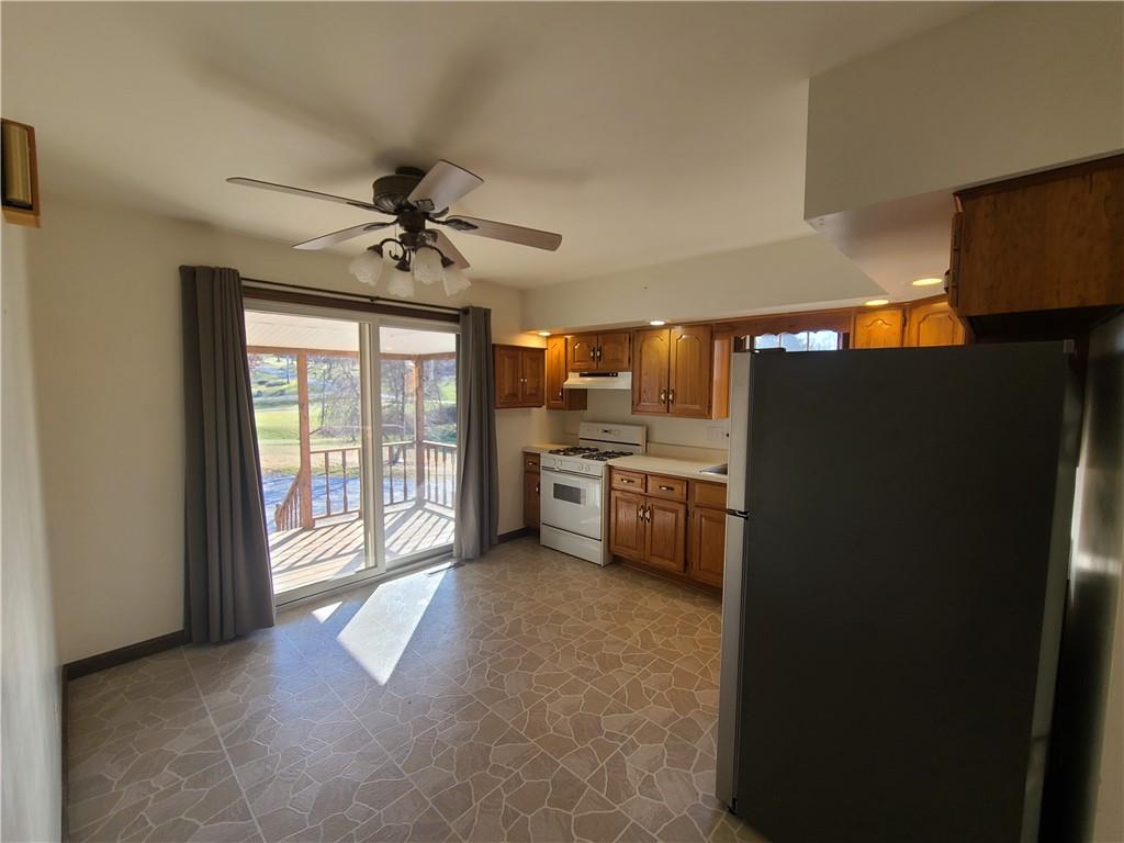 437 Pittsburgh Road Rochester, PA 15074 - Photo 8 of 25 a view of a kitchen with a sink a refrigerator and windows