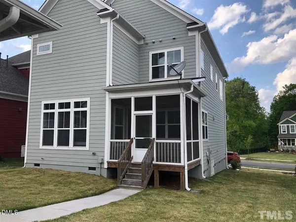 a view of a house with a yard and sitting area