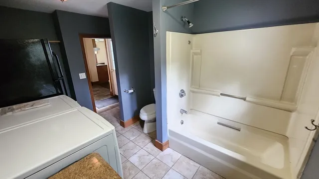 a bathroom with a tub and a shower