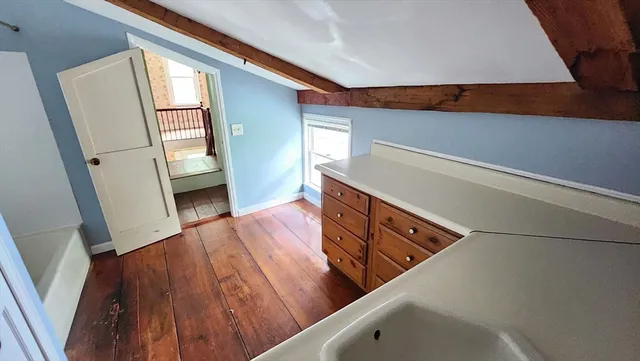 a view of an empty room and wooden floor