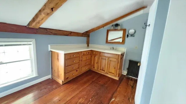 a view of a hallway with entryway wooden floor and front door