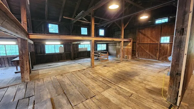 a view of a room with wooden floor