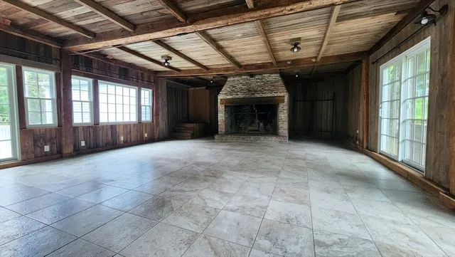 a view of an empty room with a fireplace