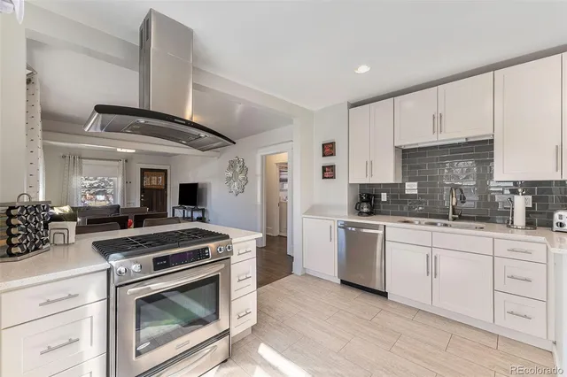 a kitchen with cabinets appliances and a sink
