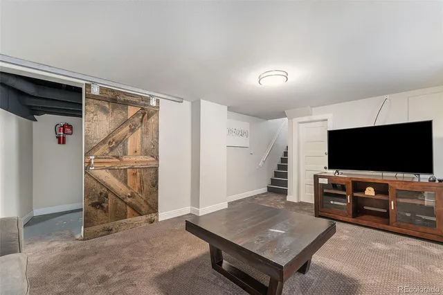 a living room with a flat screen tv and gym equipment