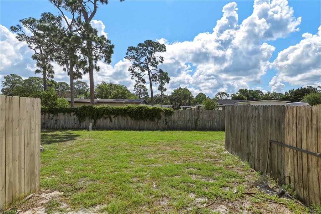 4799 Sisson Road Titusville, FL 32780 - Photo 22 of 23 a view of a backyard with wooden fence