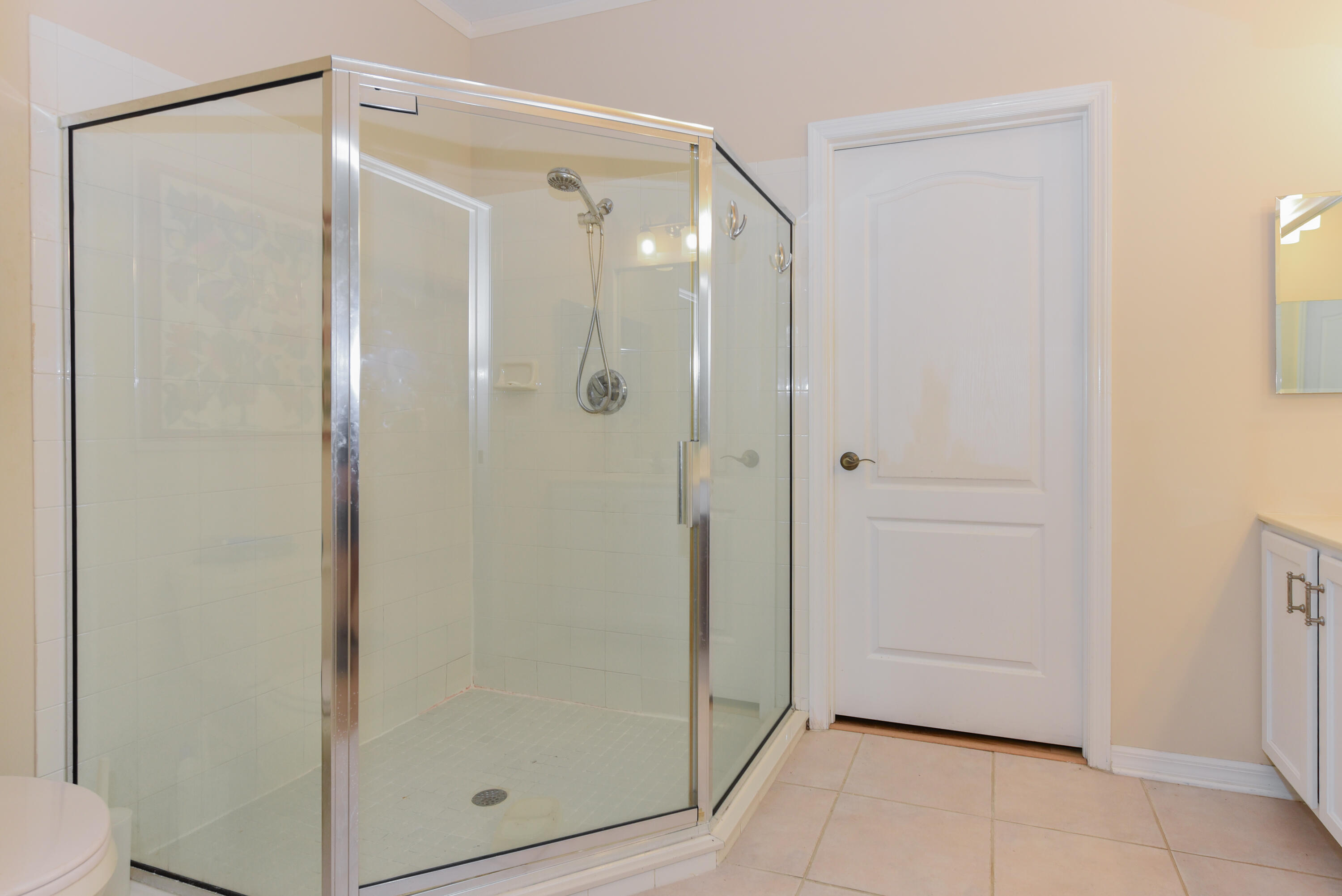 1567 Southwest Harbour Isles Circle, Unit 65 St. Lucie West, FL 34986 - Photo 11 of 35 a bathroom with a glass shower door