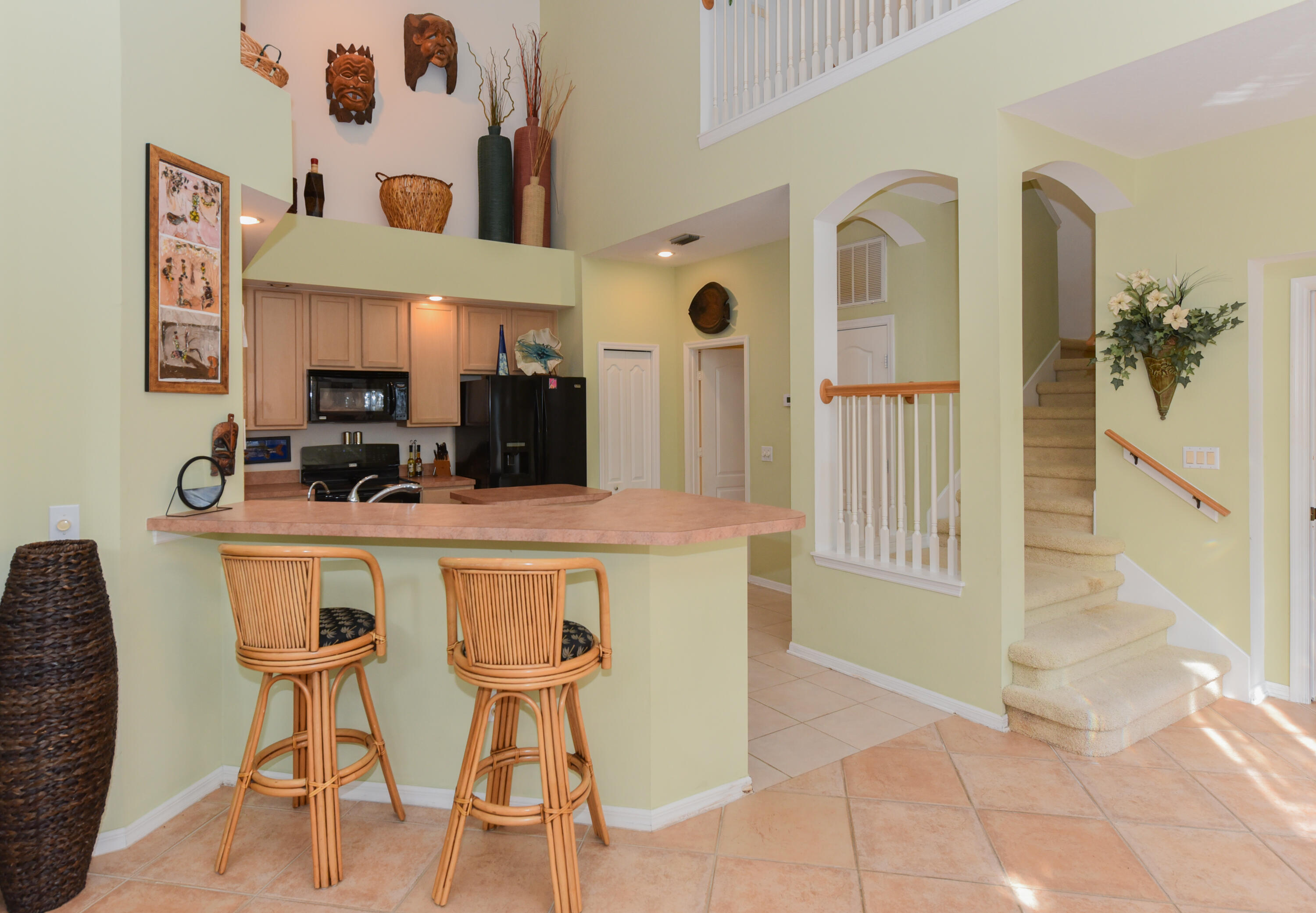 1567 Southwest Harbour Isles Circle, Unit 65 St. Lucie West, FL 34986 - Photo 12 of 35 a kitchen with stainless steel appliances kitchen island granite countertop a table and chairs in it