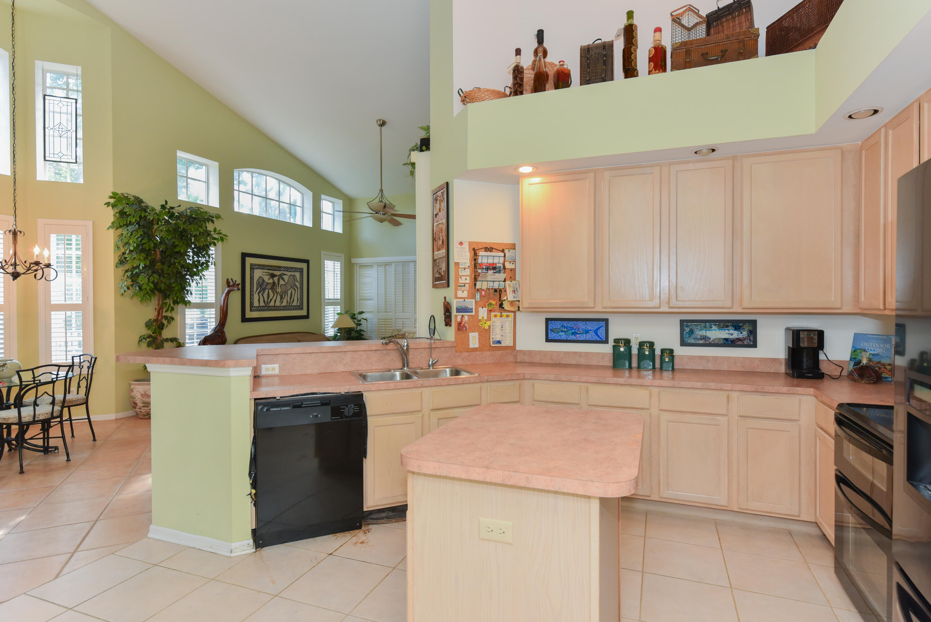 1567 Southwest Harbour Isles Circle, Unit 65 St. Lucie West, FL 34986 - Photo 14 of 35 a kitchen with a sink and cabinets