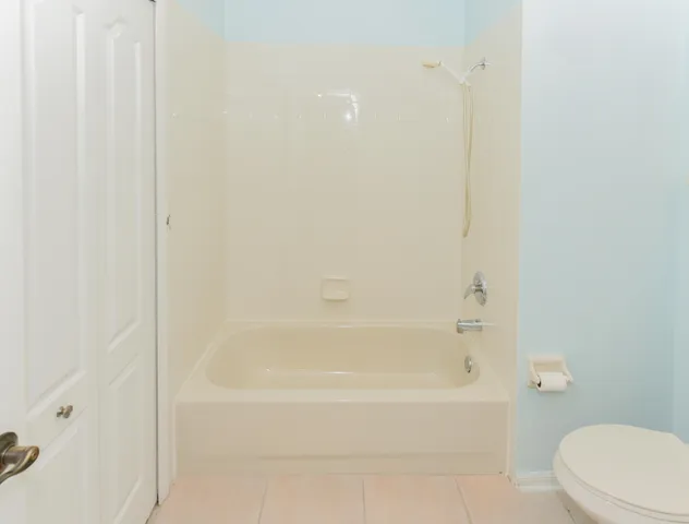 a white toilet sitting next to a bathroom sink