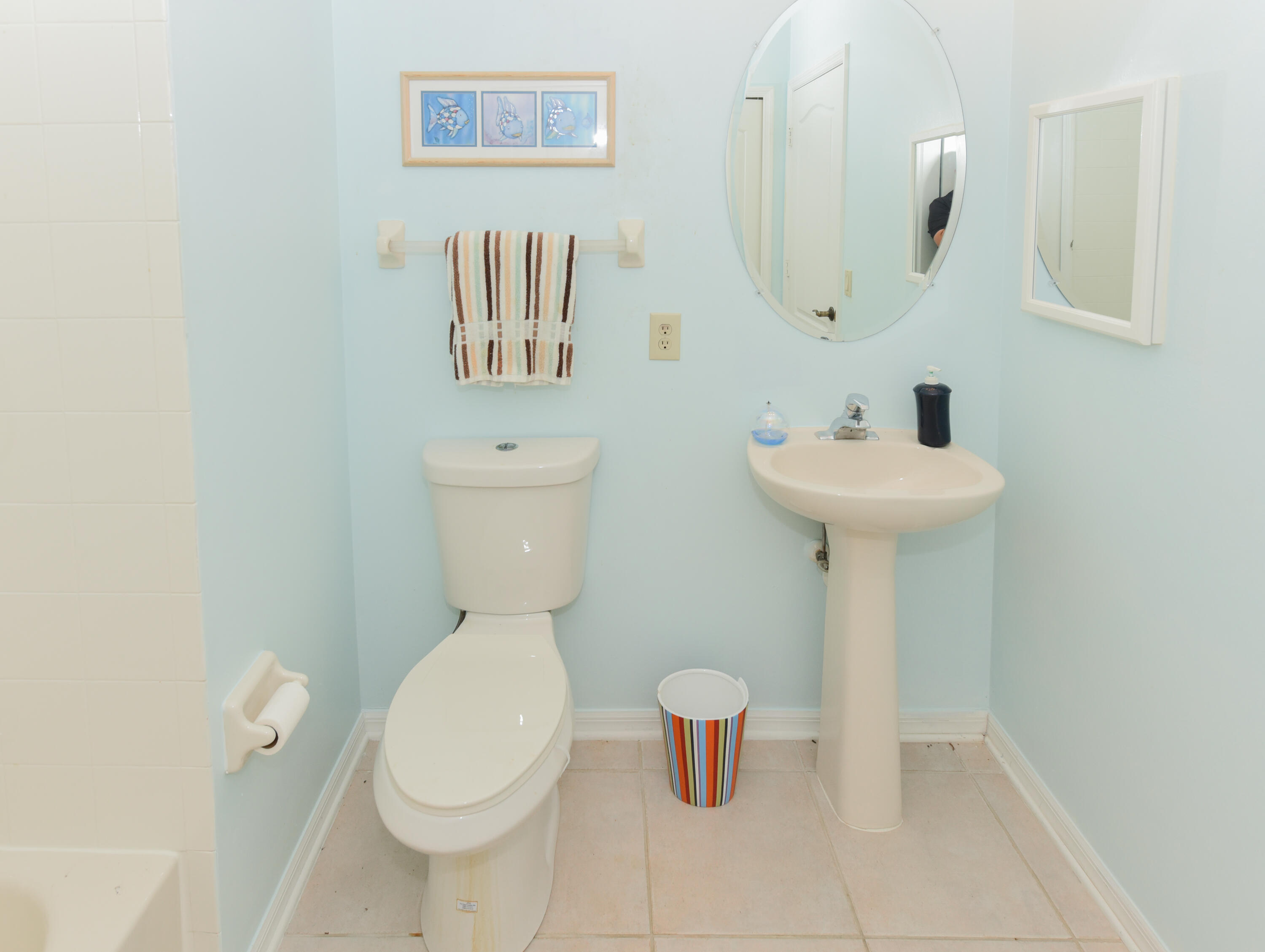 1567 Southwest Harbour Isles Circle, Unit 65 St. Lucie West, FL 34986 - Photo 17 of 35 a white toilet sitting next to a bathroom sink