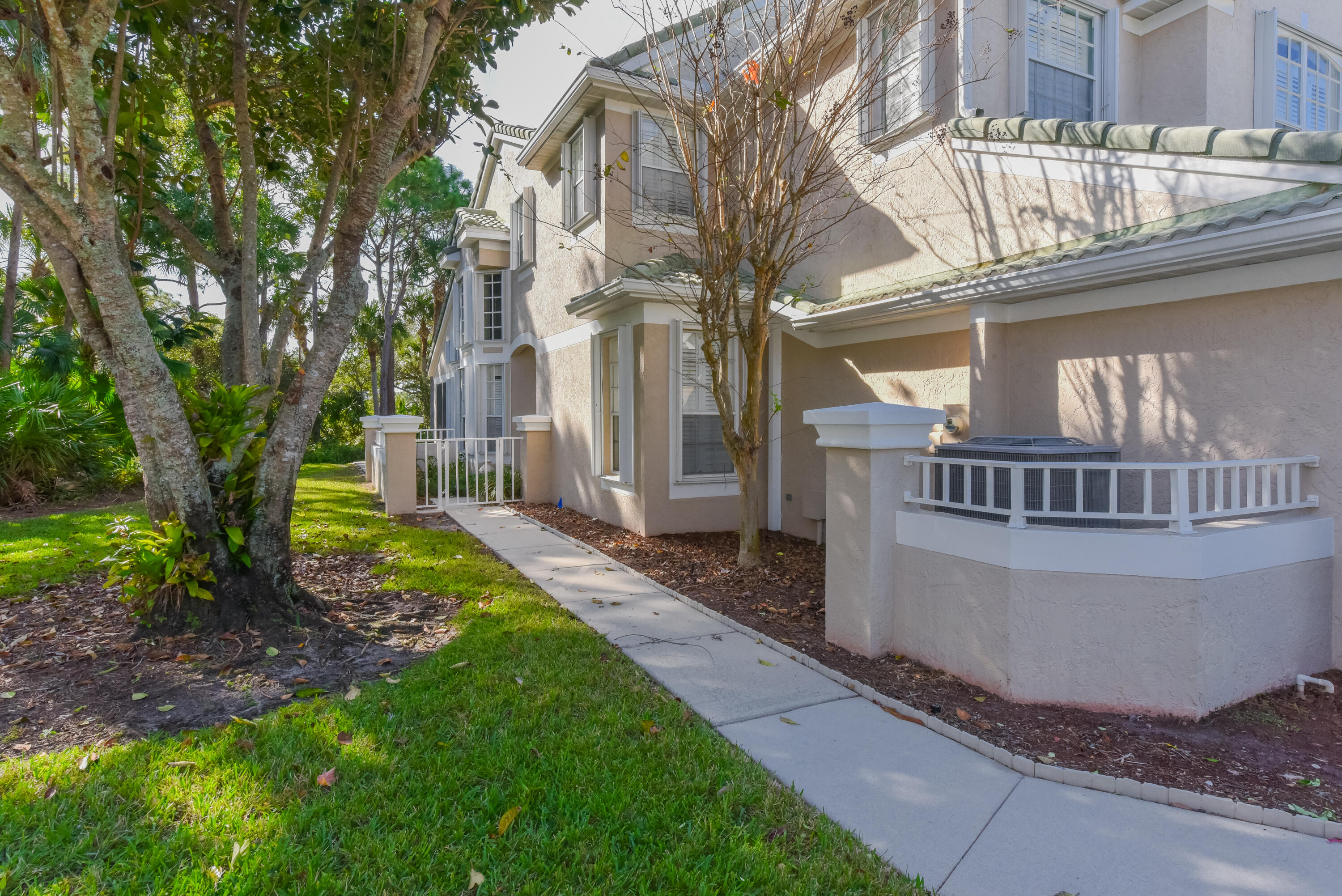 1567 Southwest Harbour Isles Circle, Unit 65 St. Lucie West, FL 34986 - Photo 2 of 35 a view of a house with a yard and deck