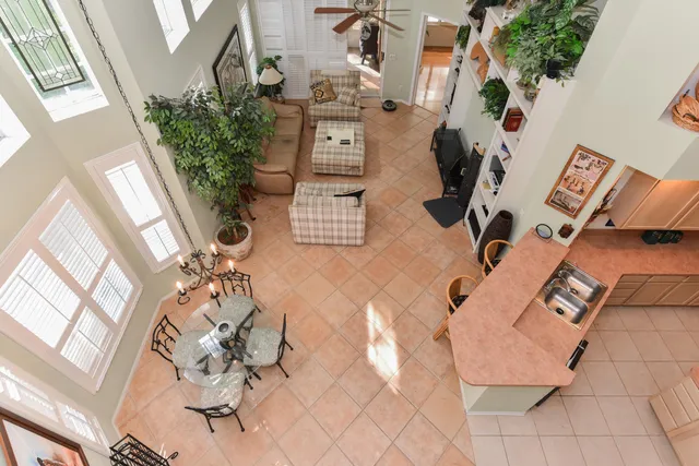 a living room with furniture and a floor to ceiling window