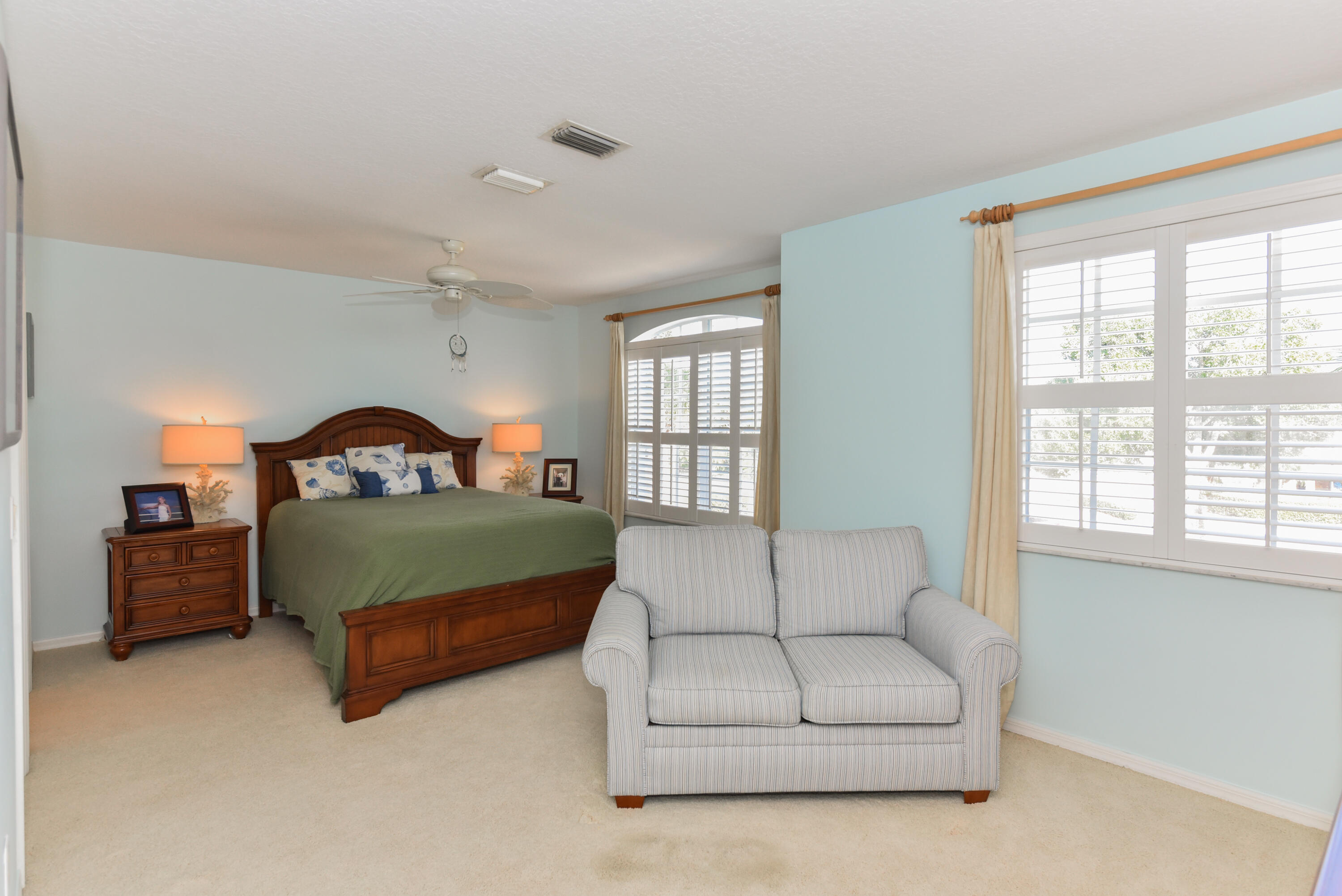 1567 Southwest Harbour Isles Circle, Unit 65 St. Lucie West, FL 34986 - Photo 25 of 35 a bedroom with a bed couch and window