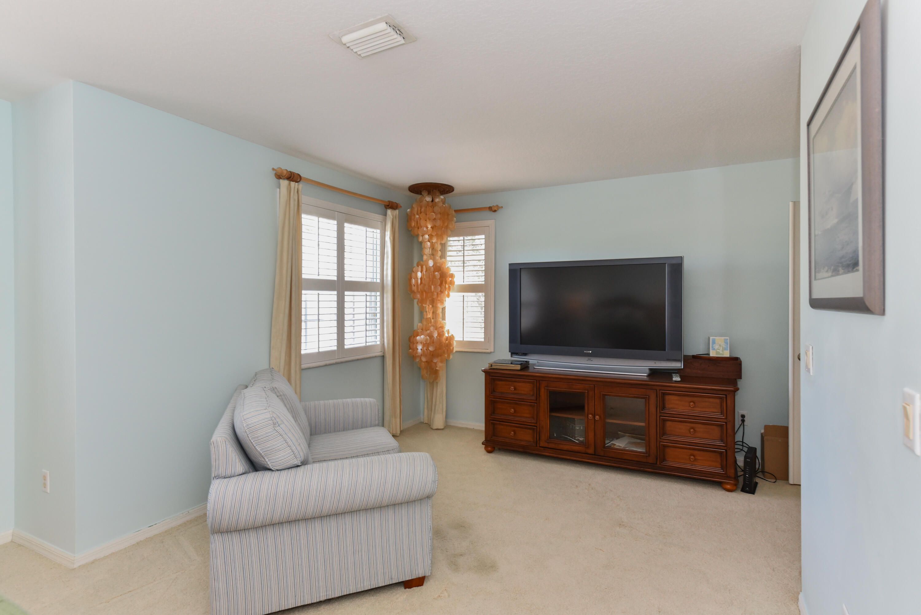 1567 Southwest Harbour Isles Circle, Unit 65 St. Lucie West, FL 34986 - Photo 26 of 35 a living room with furniture and a flat screen tv