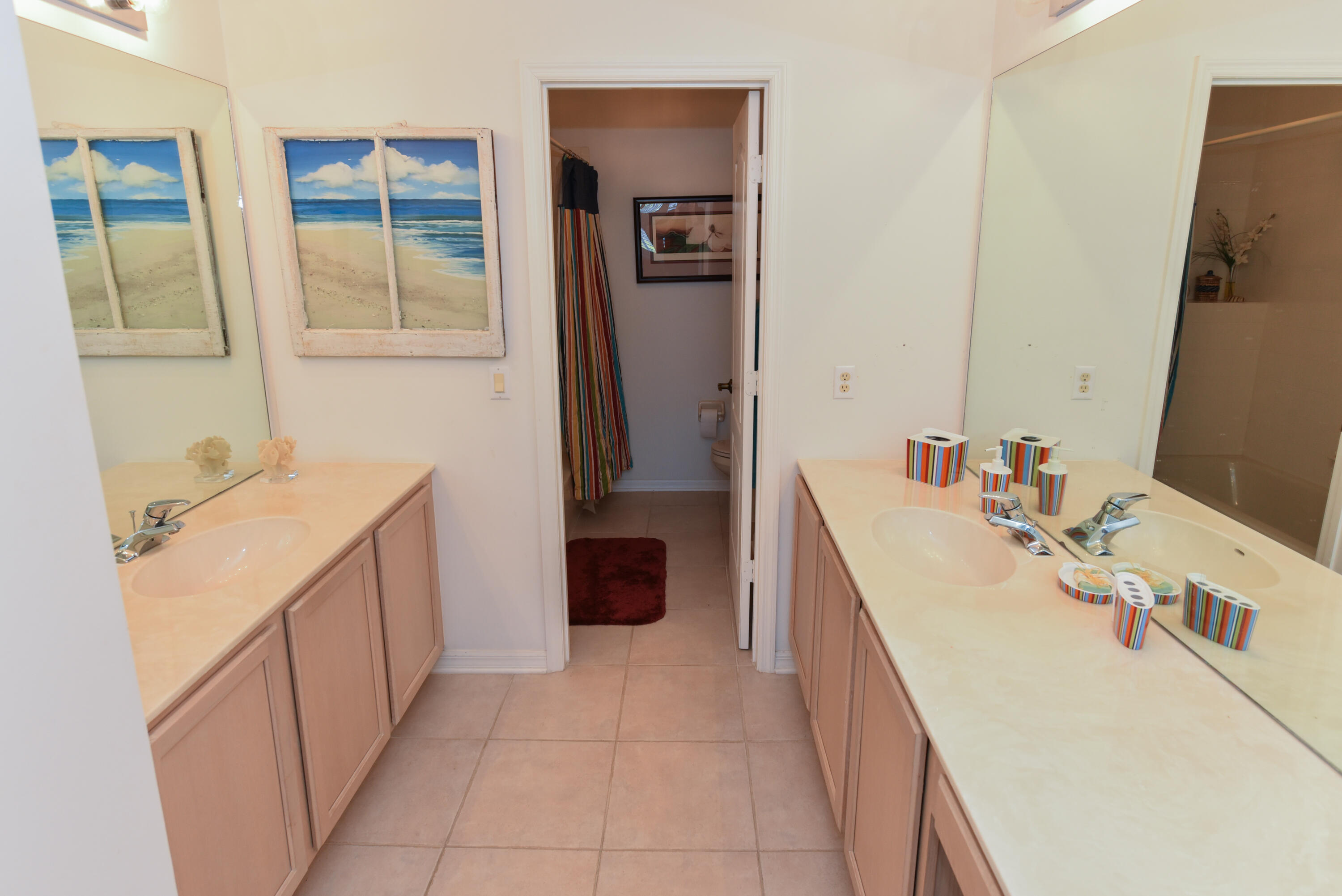 1567 Southwest Harbour Isles Circle, Unit 65 St. Lucie West, FL 34986 - Photo 27 of 35 a bathroom with a tub sink and mirror