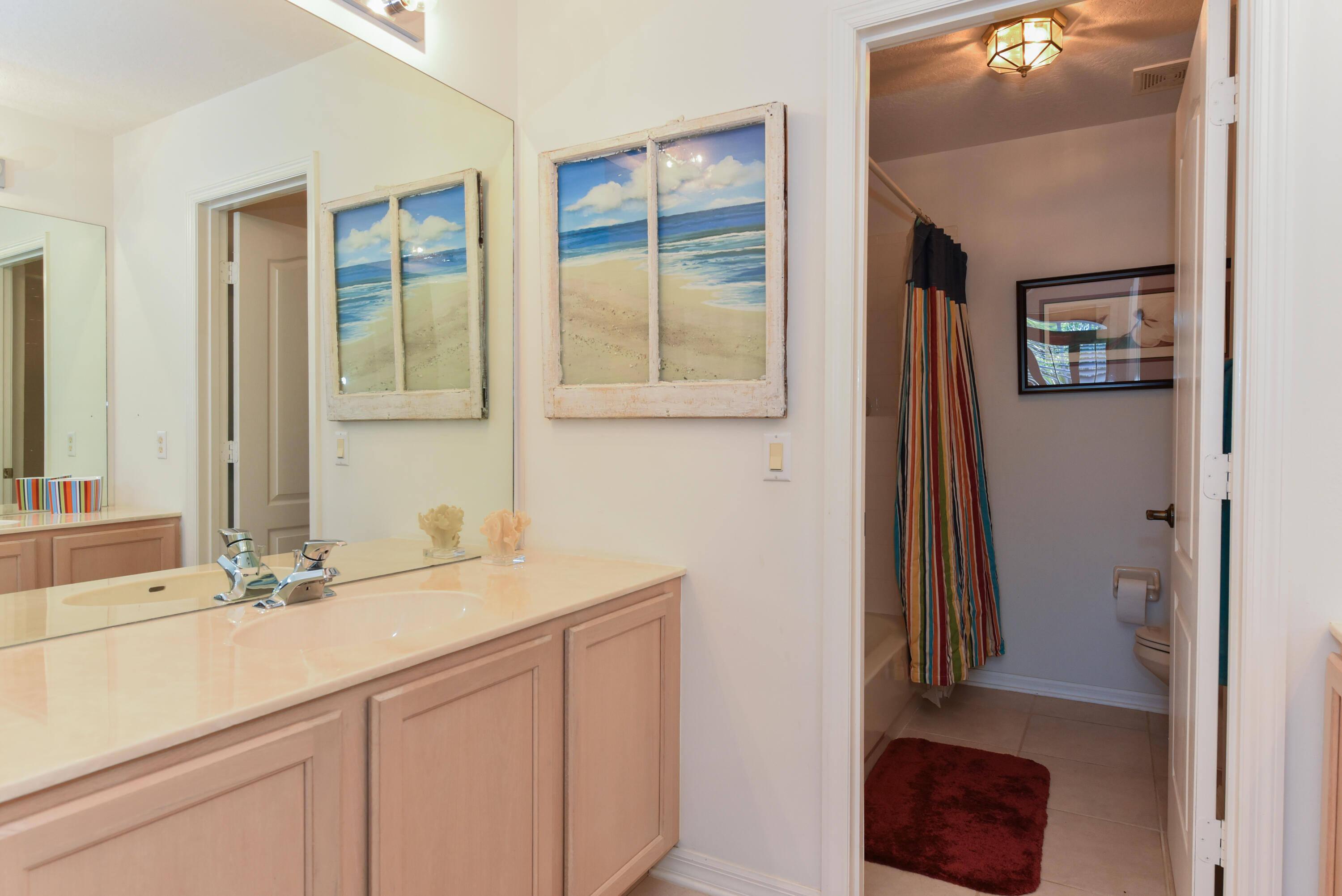 1567 Southwest Harbour Isles Circle, Unit 65 St. Lucie West, FL 34986 - Photo 28 of 35 a bathroom with a sink and a mirror