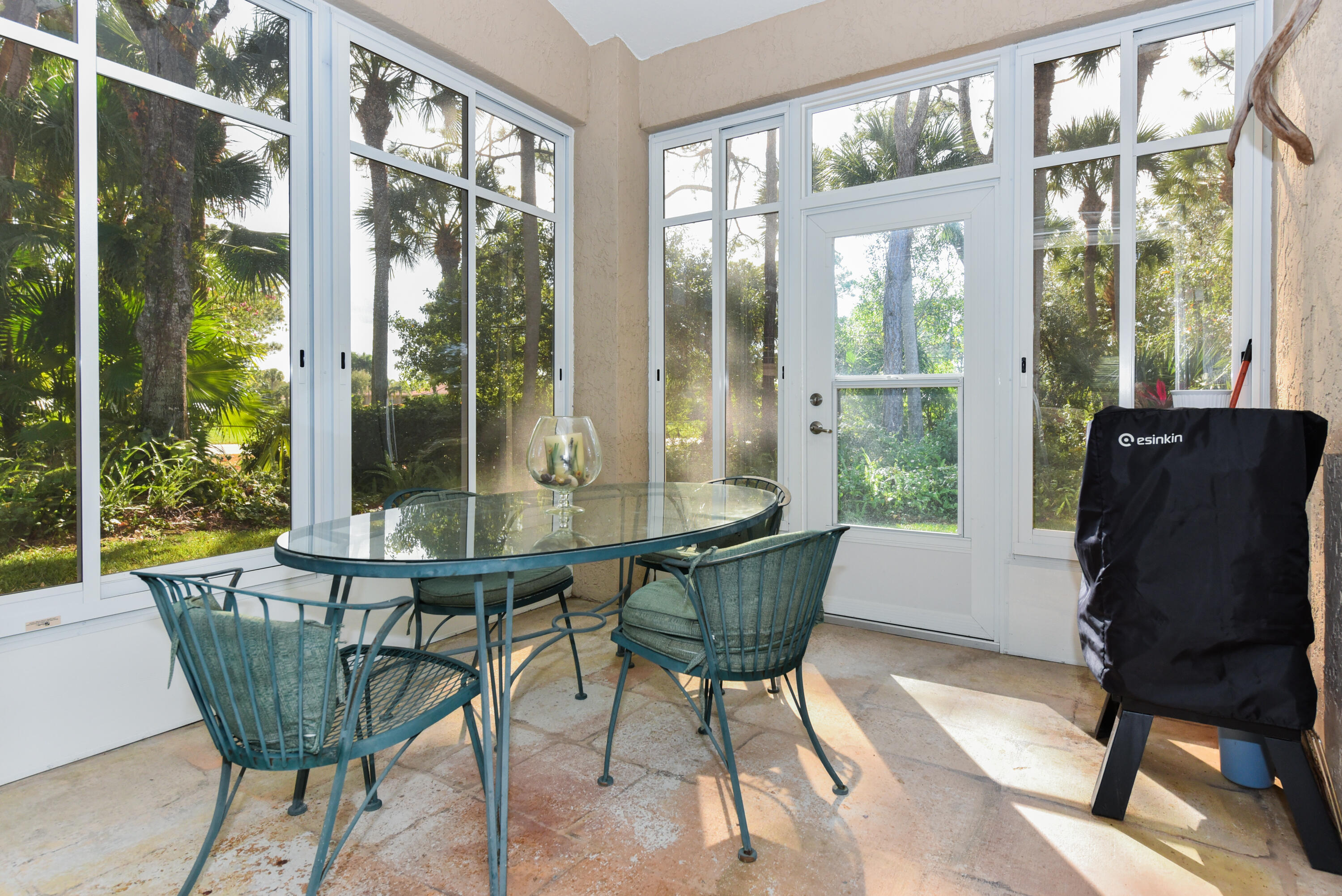 1567 Southwest Harbour Isles Circle, Unit 65 St. Lucie West, FL 34986 - Photo 30 of 35 a view of a dining room with furniture window and outside view