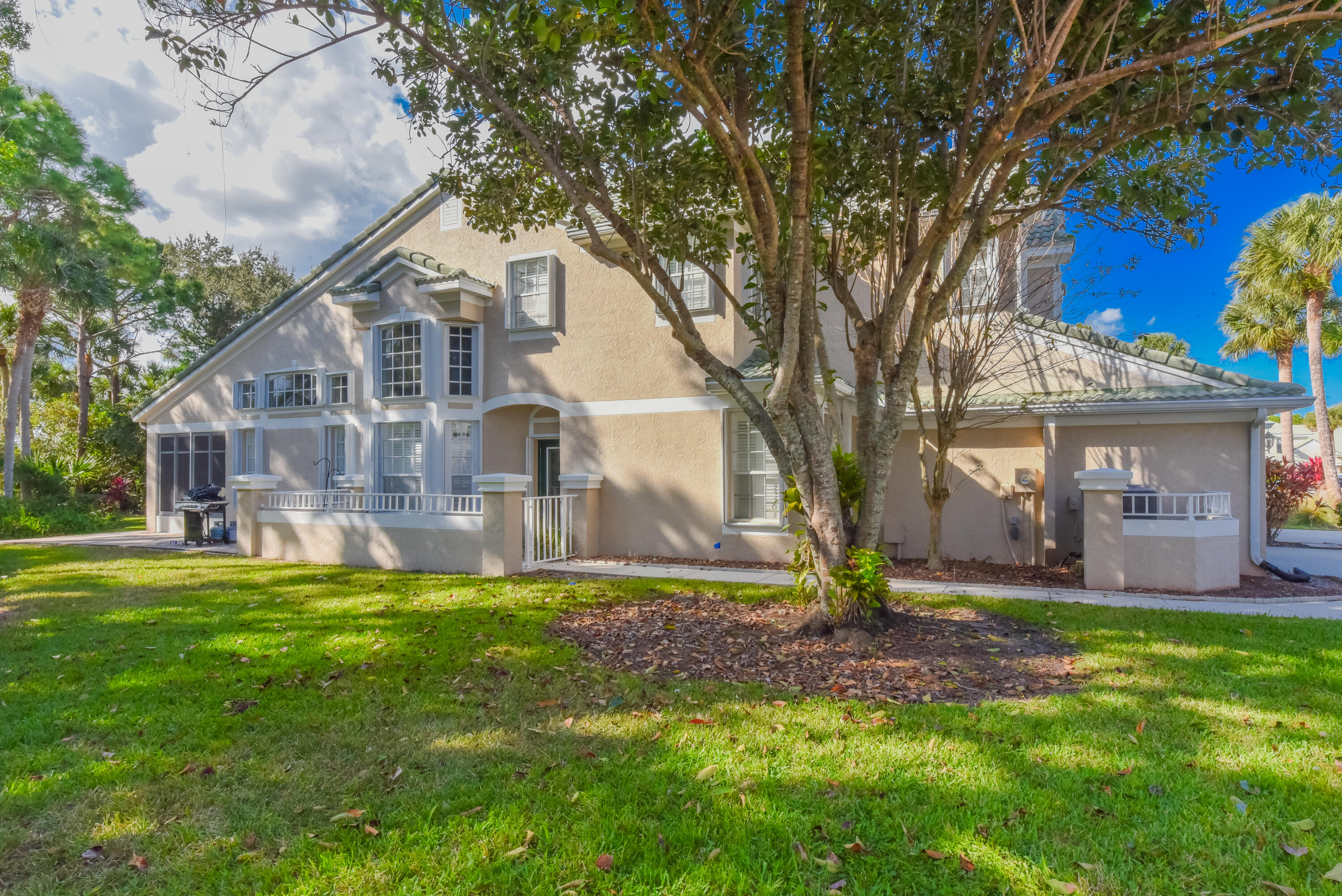 1567 Southwest Harbour Isles Circle, Unit 65 St. Lucie West, FL 34986 - Photo 32 of 35 a view of a house with a yard