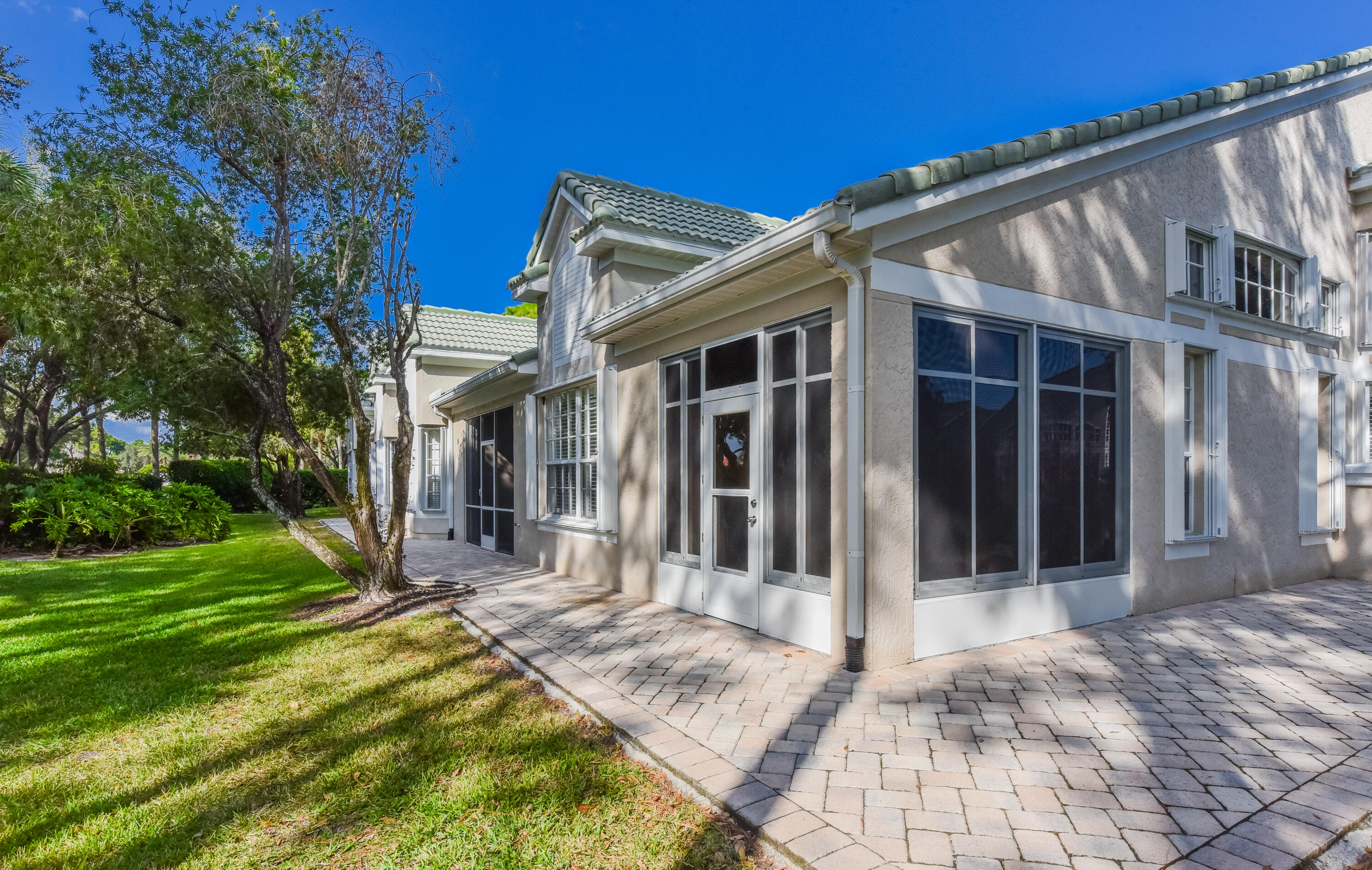 1567 Southwest Harbour Isles Circle, Unit 65 St. Lucie West, FL 34986 - Photo 33 of 35 a view of a house with a yard