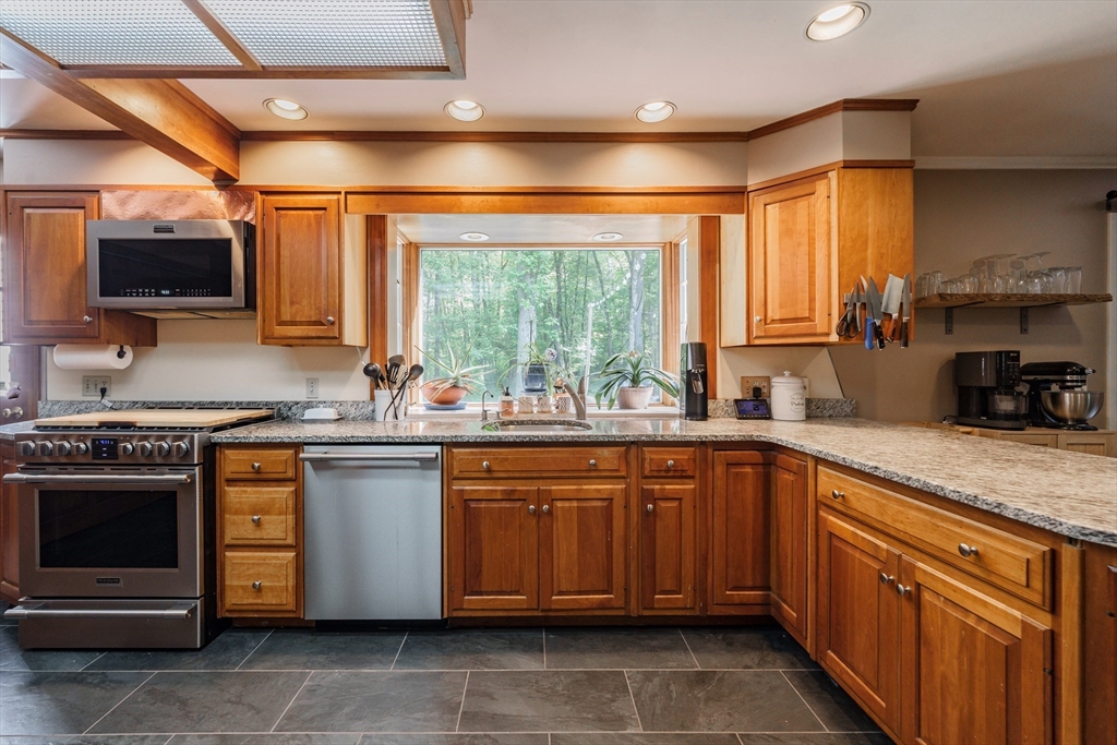 36 Old House Road Montgomery, MA 01085 - Photo 13 of 42 a kitchen with stainless steel appliances granite countertop a sink stove and refrigerator
