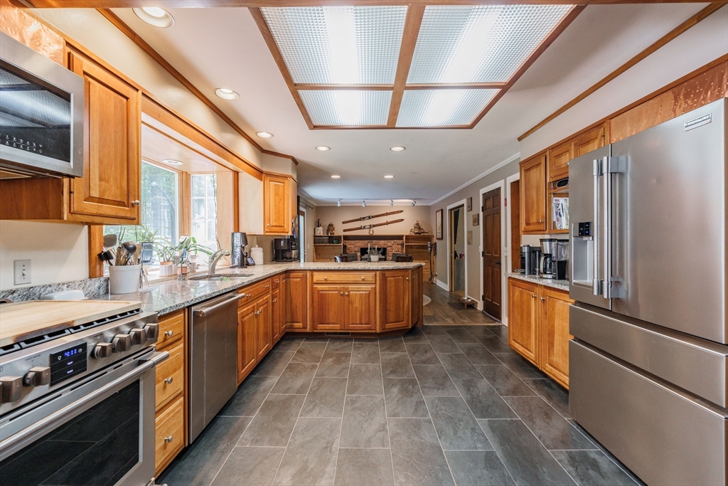 36 Old House Road Montgomery, MA 01085 - Photo 15 of 42 a large kitchen with stainless steel appliances granite countertop a large stove a sink dishwasher a refrigerator and white cabinets with wooden floor
