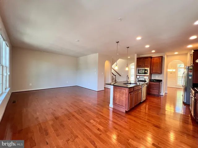 a view of kitchen with cabinets microwave and stove