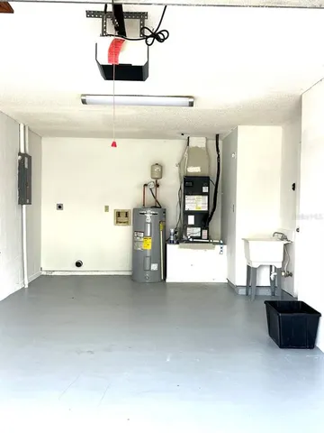 a living room with a couch and potted plant