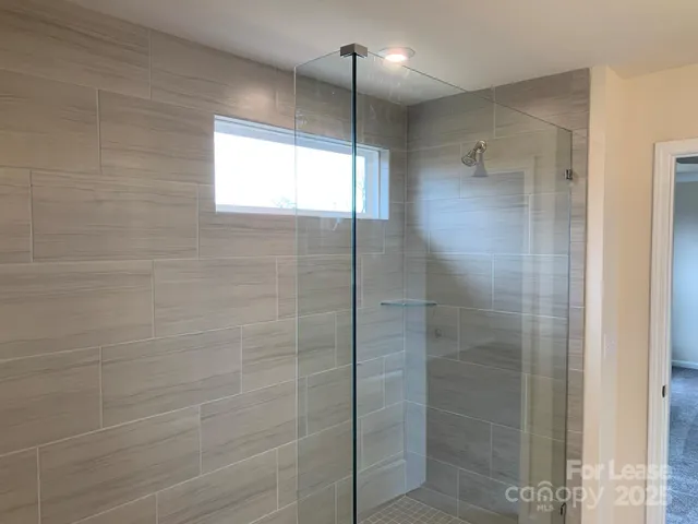 a bathroom with a glass shower door