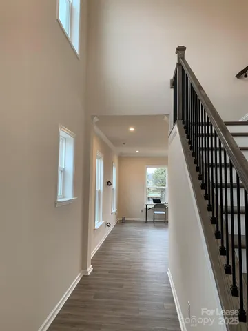 a view of entryway and hall with wooden floor