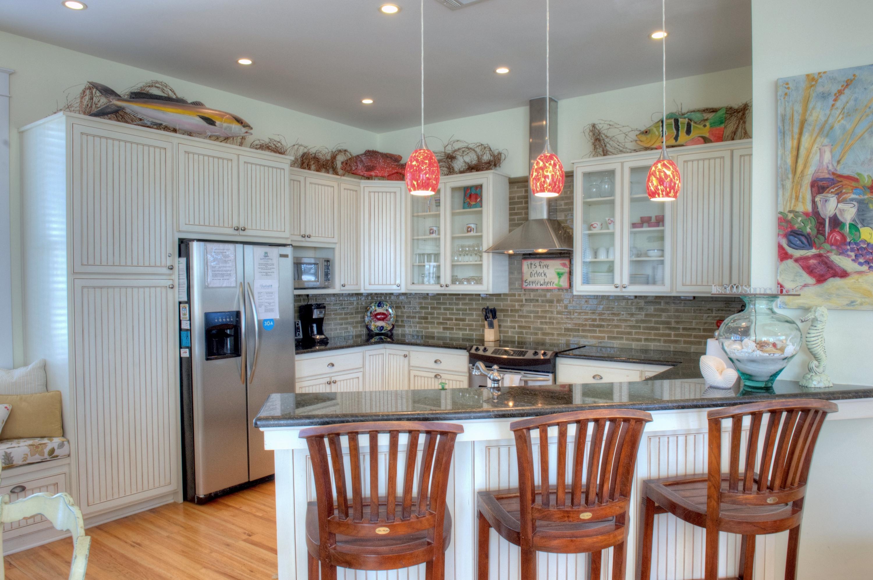 97 Chelsea Loop Road Santa Rosa Beach, FL 32459 - Photo 3 of 26 a kitchen with stainless steel appliances granite countertop a dining table chairs sink and stove top oven