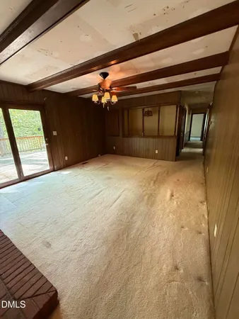 a view of an empty room with a fireplace