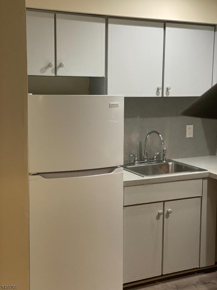 161 Evergreen Road, Unit 13A Edison, NJ 08837 - Photo 4 of 12 a kitchen with a sink and a refrigerator