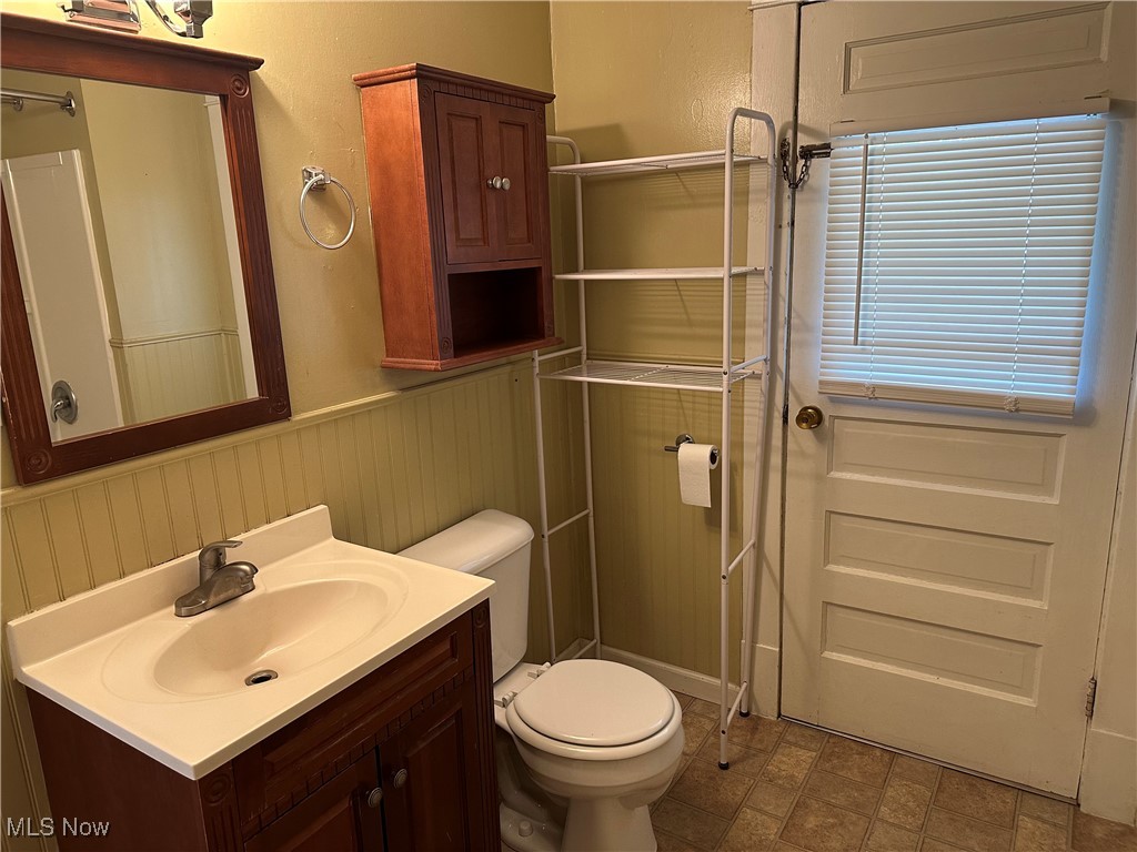 1596 Wood Road Cleveland Heights, OH 44121 - Photo 18 of 25 Bathroom featuring wainscoting, vanity, and a shower