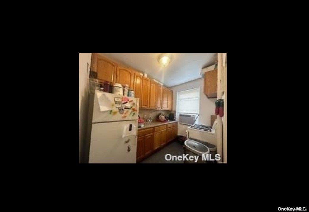 21-78 35th Street, Unit 5F Queens, NY 11105 - Photo 6 of 8 a open refrigerator in kitchen