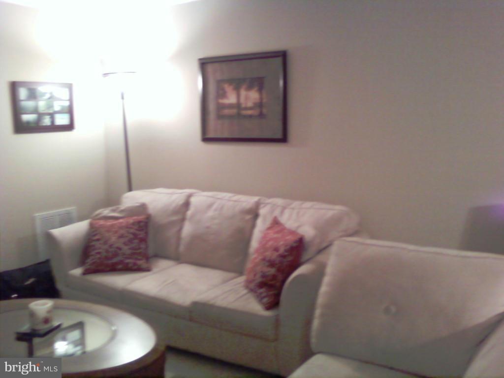 14800 Rydell Road, Unit 204 Centreville, VA 20121 - Photo 9 of 9 a living room with furniture and a couch