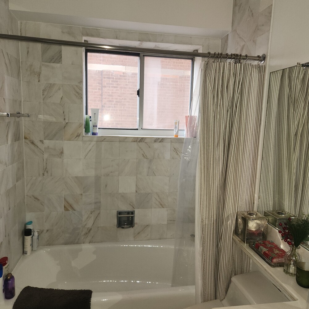 420 East 58th Street, Unit 16C Manhattan, NY 10022 - Photo 7 of 8 a bathroom with a bathtub and shower
